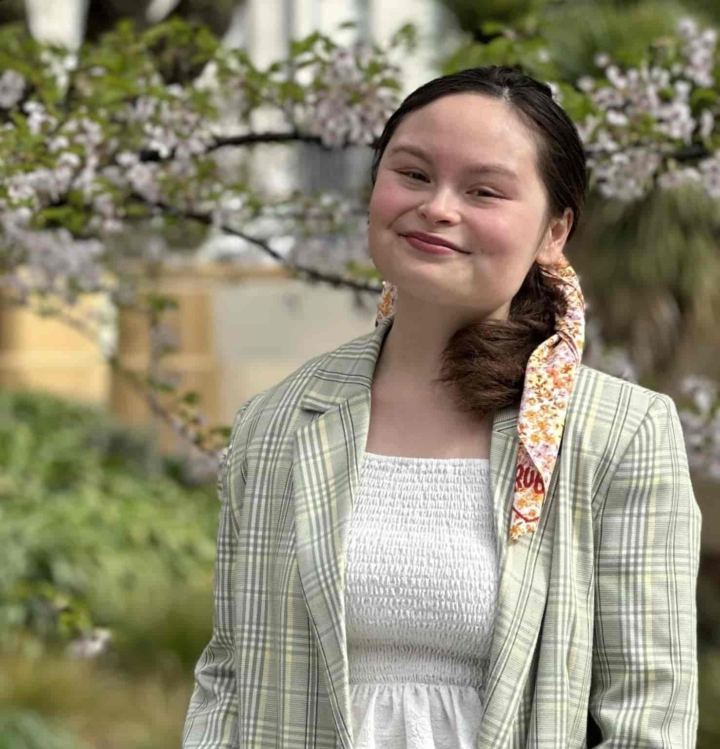 janine wearing a canteen bandanna and a green top. she is smiling at the camera