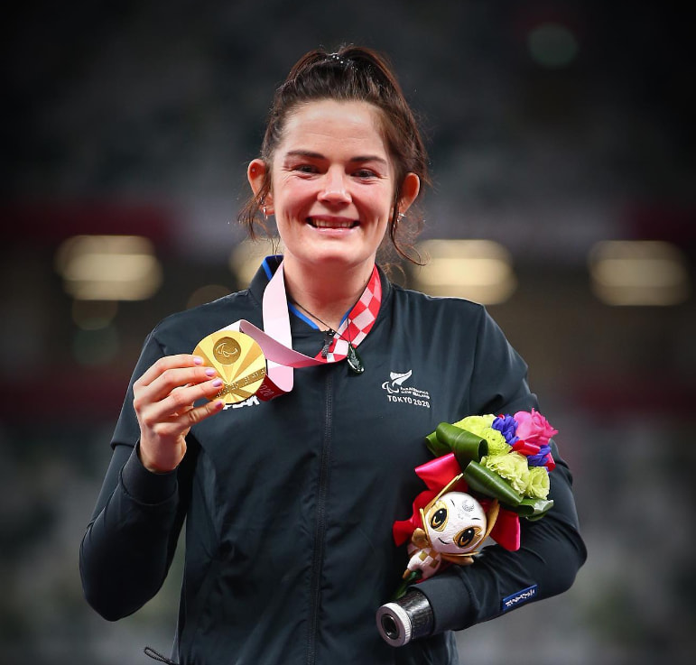 canteen ambassador holding up a medal