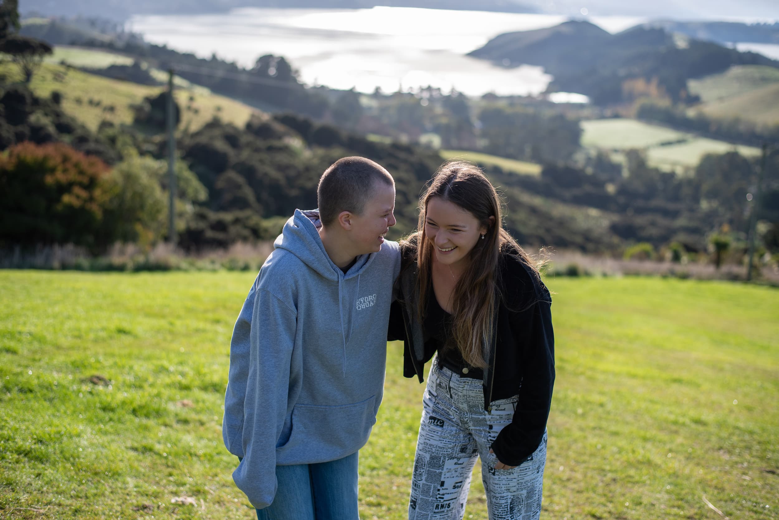 two young people impacted by cancer are laughing together