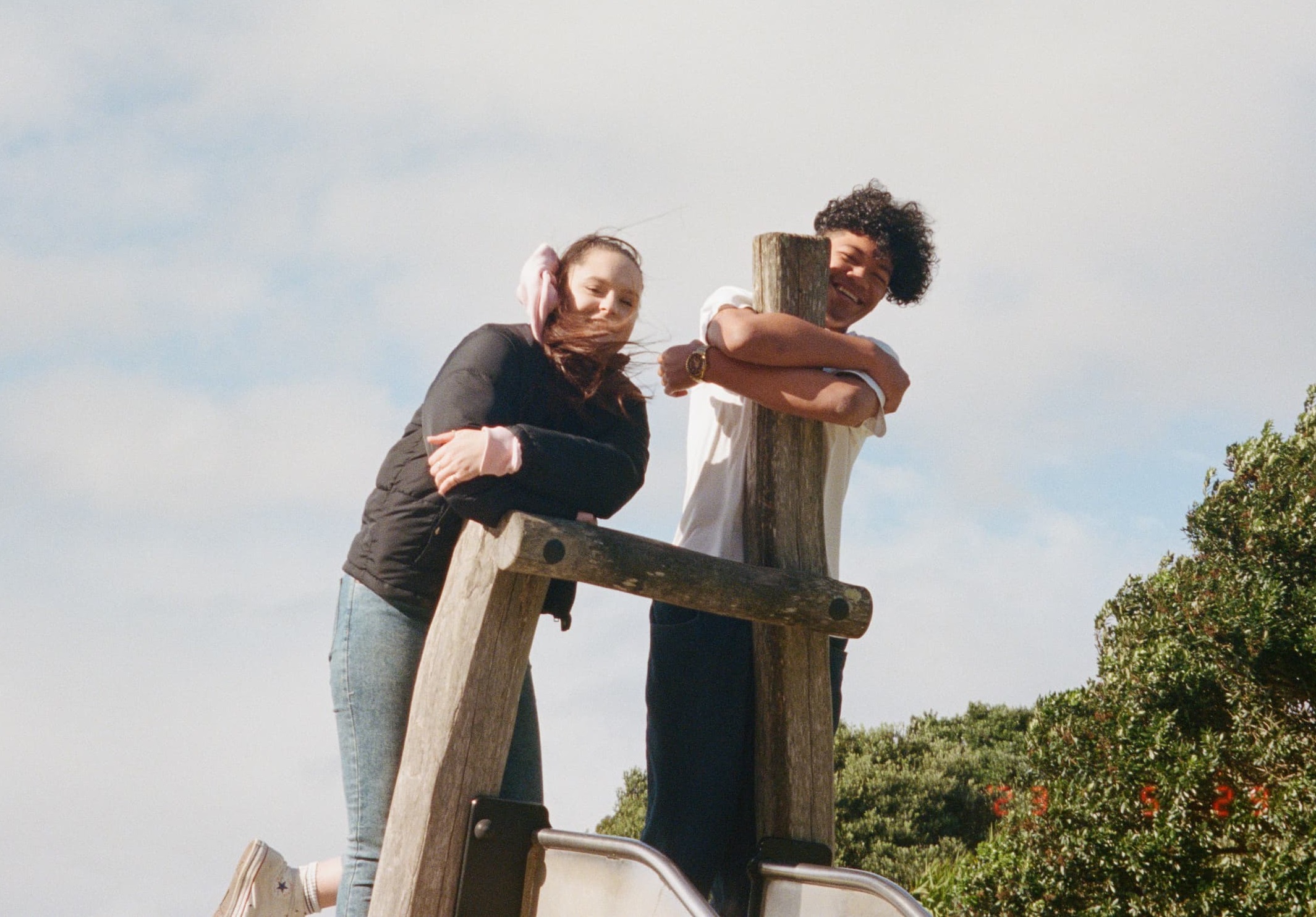 two young people having fun at a playground