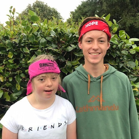 two siblings named finn and ella who received family cancer support from canteen are wearing canteen bandannas