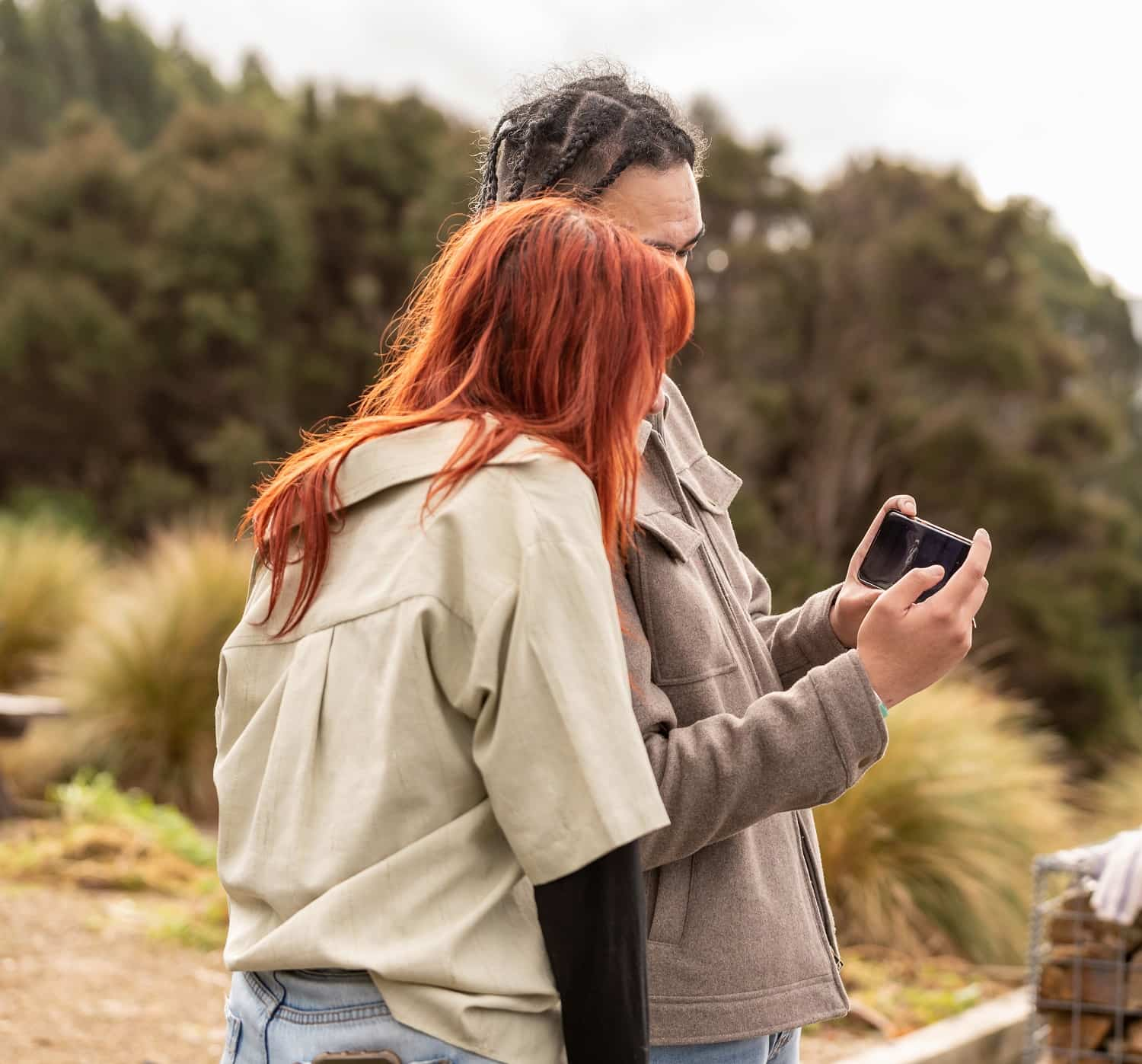 two young people accessing online support from canteen through their phone