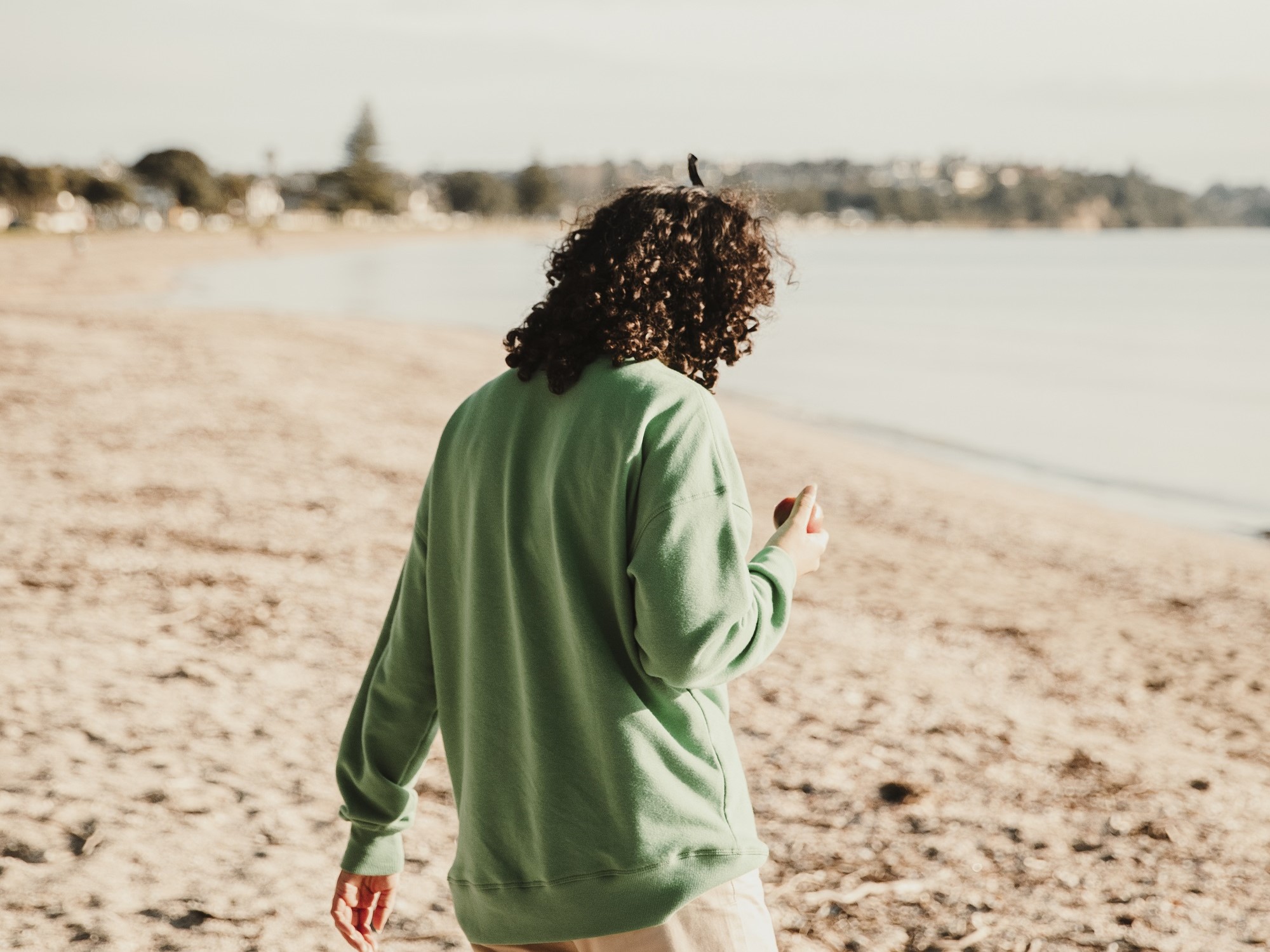 Rangatahi impacted by breast cancer reflecting on the beach