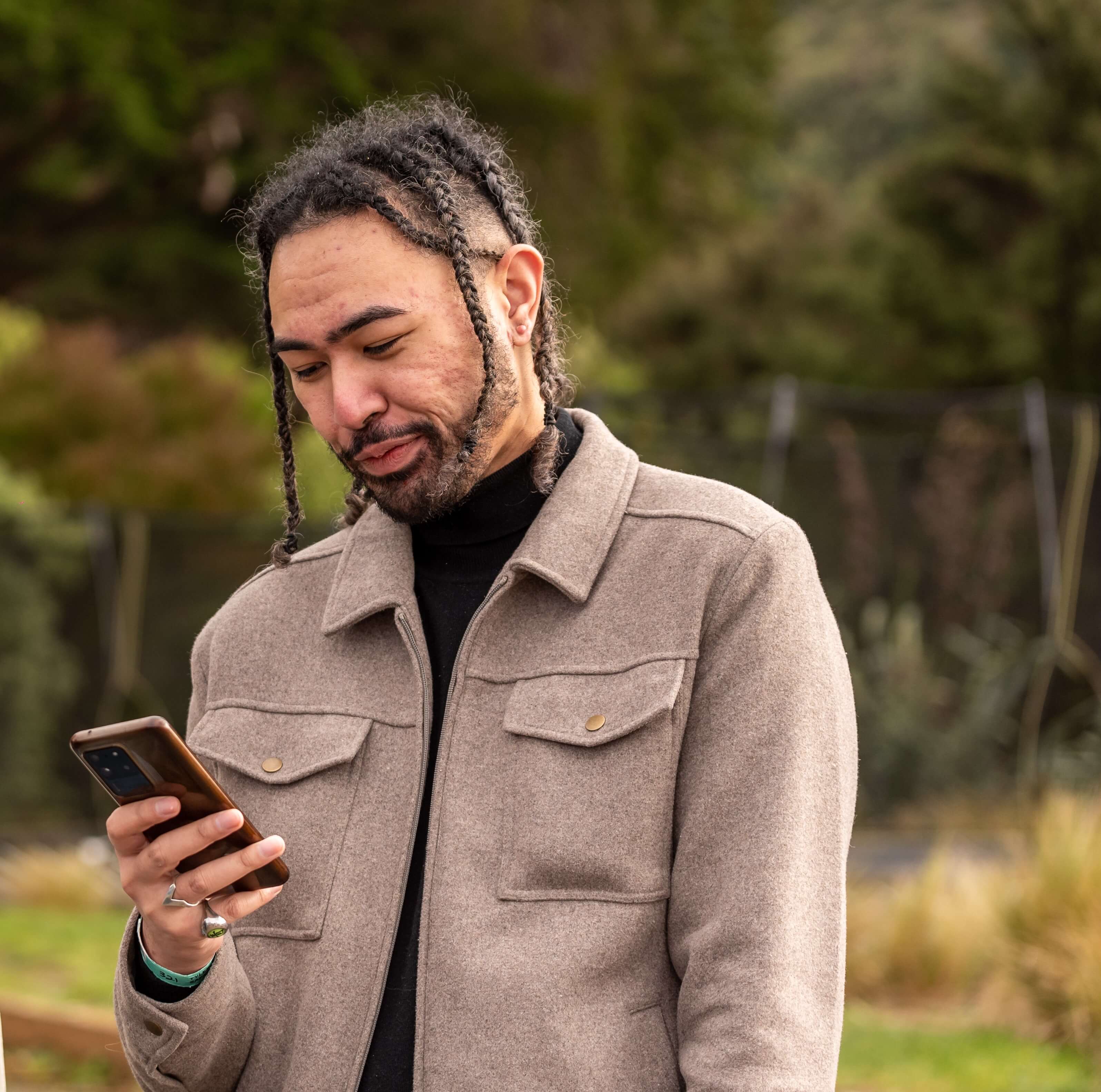 young person is on their phone and getting teenage cancer support through canteen connect